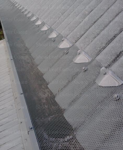 Steep pitch roof now protected with leaf guard - Metal gutter guard